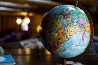 desk globe on table by Kyle Glenn courtesy of Unsplash.