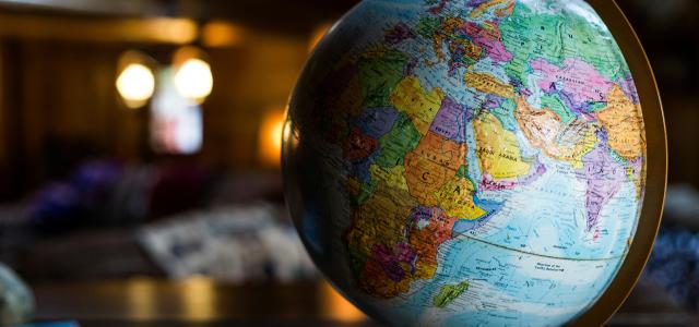 desk globe on table by Kyle Glenn courtesy of Unsplash.