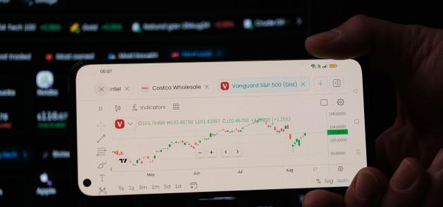 A person holding a business card in front of a computer screen by Jean-Luc Picard courtesy of Unsplash.